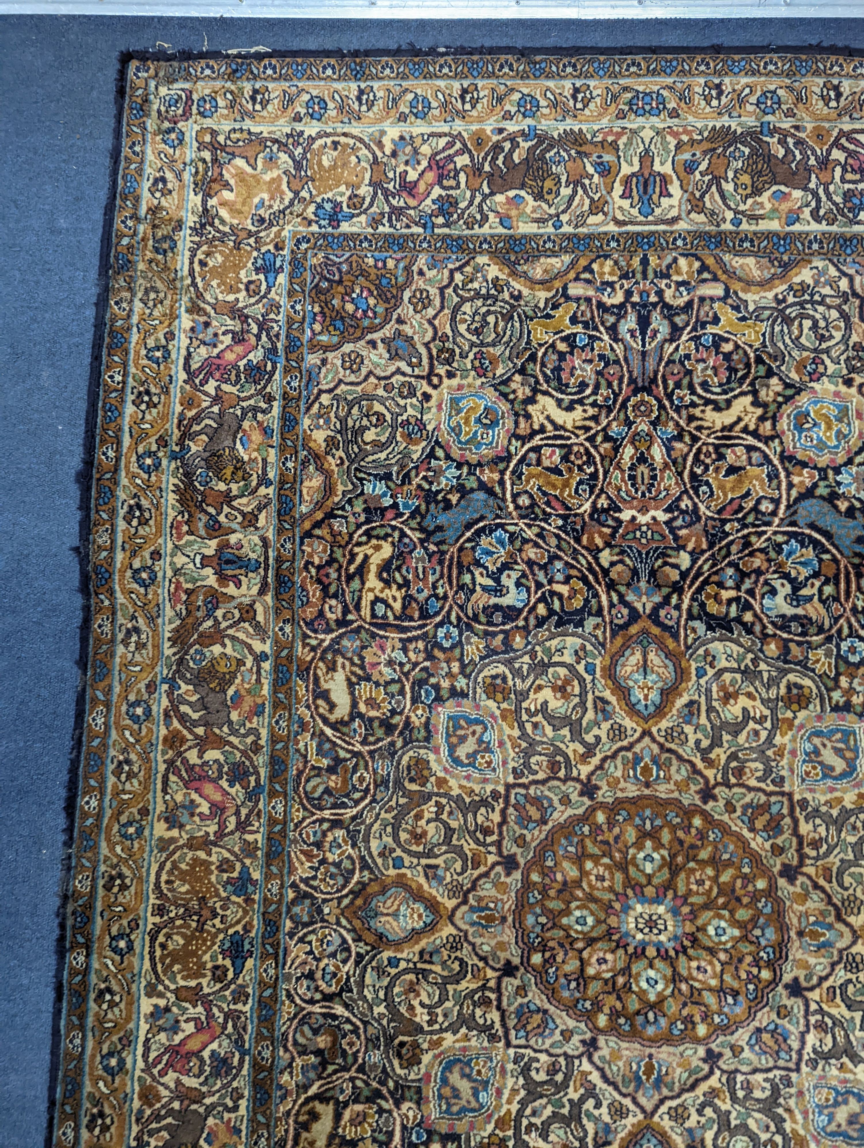 A Kashan blue ground rug woven with animals. 187x125cm.